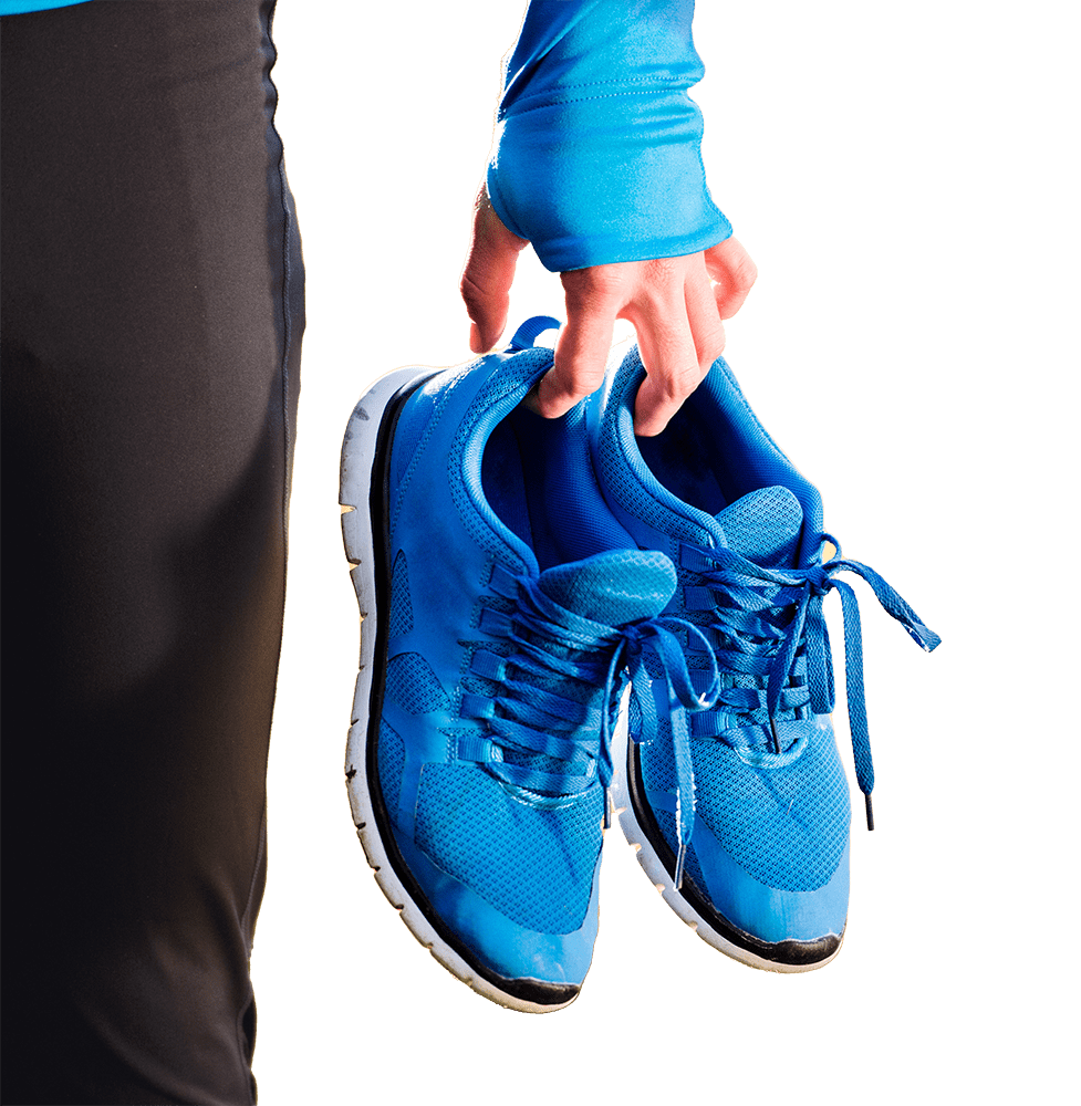 Running shoes held by woman